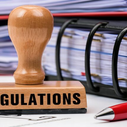 Regulations,Stamp,On,Desk,With,Red,Pen